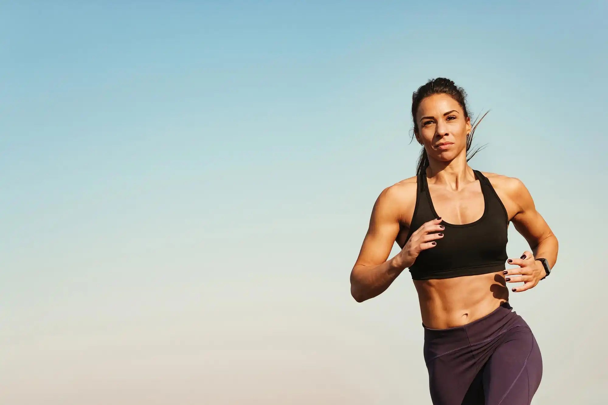 Mujer corriendo con un conjunto de ropa deportiva